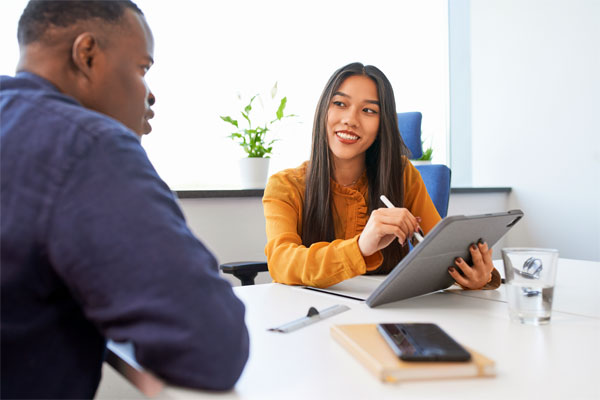 Image of two employees meeting in an office