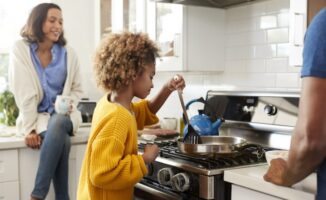 Image of parents teaching their daughter to cook