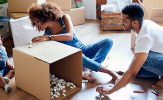 Image of a family packing boxes and preparing to move into a new home