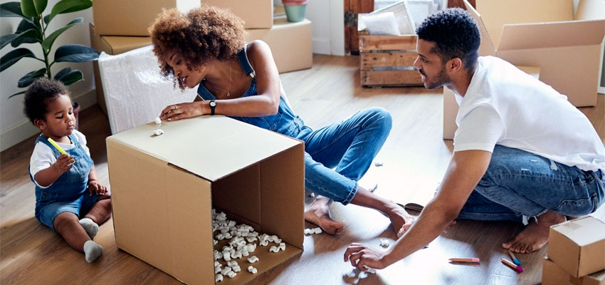 Image of a family packing boxes and preparing to move into a new home