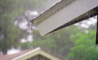 Photo of rain pouring off a roof