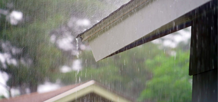 Photo of rain pouring off a roof