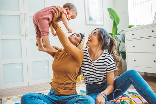 Image of a couple holding their baby