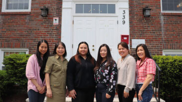 Image of the Quincy team in front of the office
