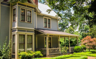 External photo of a two-story home with a front porch and landscaped yard