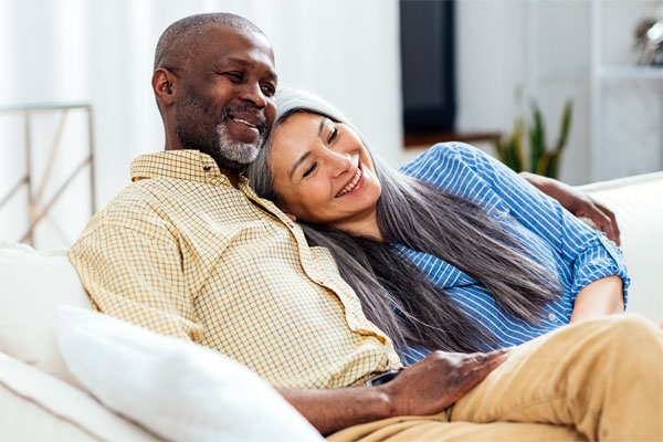 Image of a happy older couple on their couch