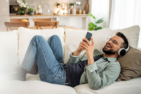 Image of a young man hanging out on his couch