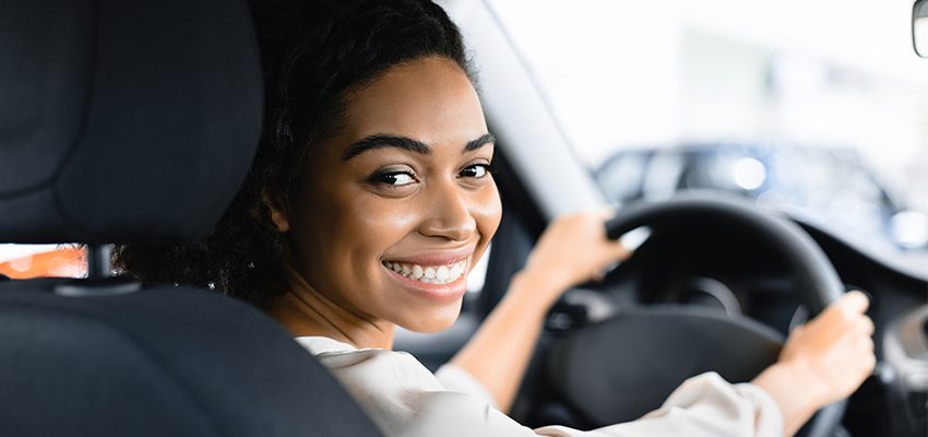 women driving her new car and car insurance