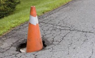 Pothole with safety cone