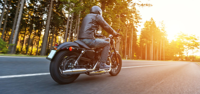 Motorcycle on tree lined street